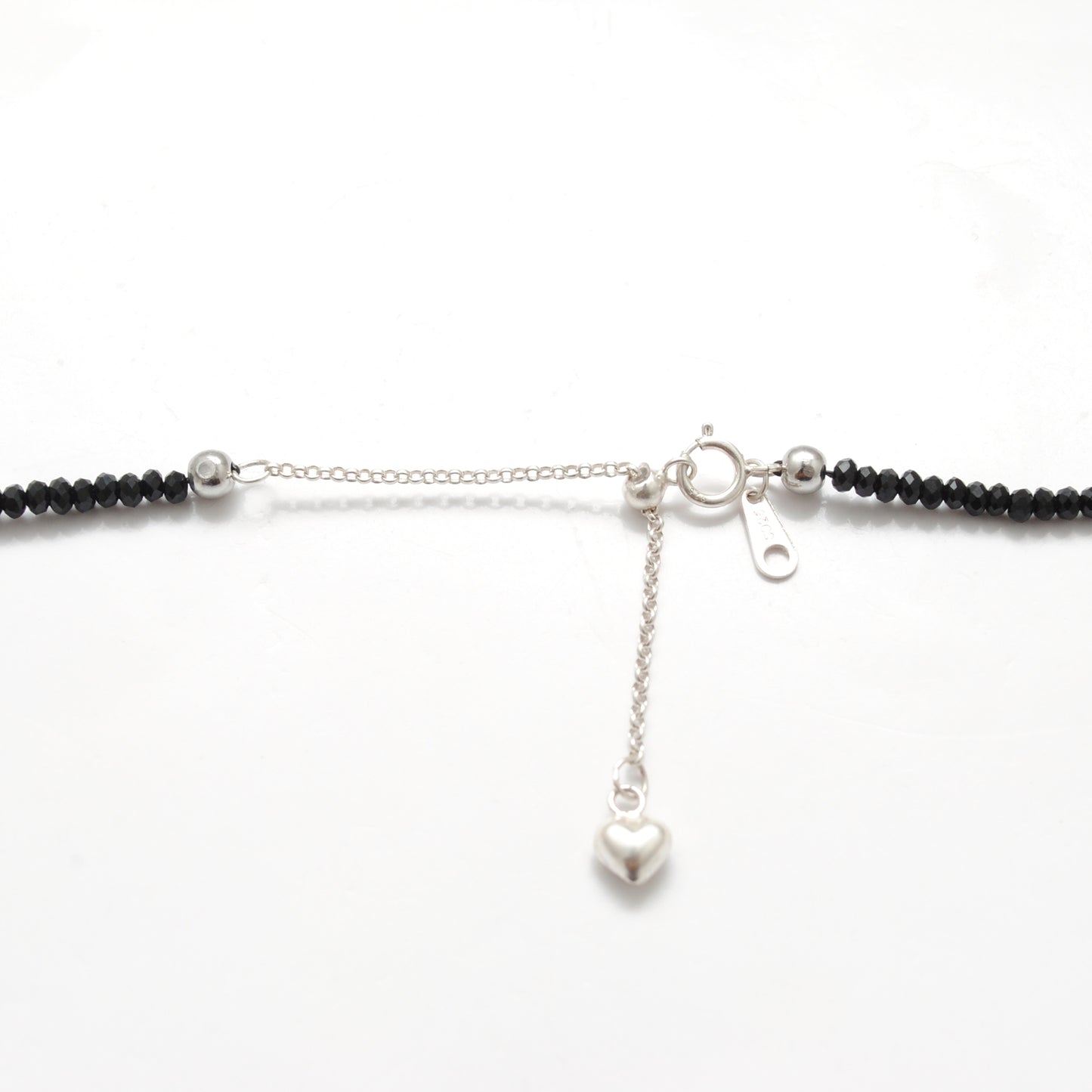 "Handmade black spinel beaded necklace with sterling silver clasp, faceted dark gemstone jewelry with subtle sparkle."