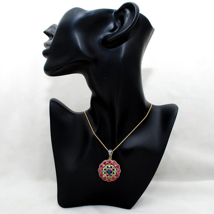 925 sterling silver pendant with pave-set diamonds, featuring vibrant ruby, blue topaz, sapphire, and peridot gemstones in an elegant design