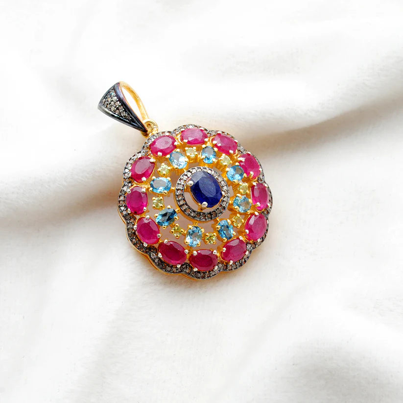 925 sterling silver pendant with pave-set diamonds, featuring vibrant ruby, blue topaz, sapphire, and peridot gemstones in an elegant design