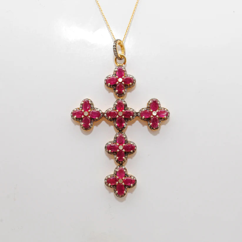 Gold-plated sterling silver pendant featuring a vivid ruby centerpiece surrounded by sparkling pavé-set diamonds in an elegant design