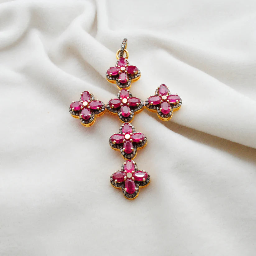 Gold-plated sterling silver pendant featuring a vivid ruby centerpiece surrounded by sparkling pavé-set diamonds in an elegant design