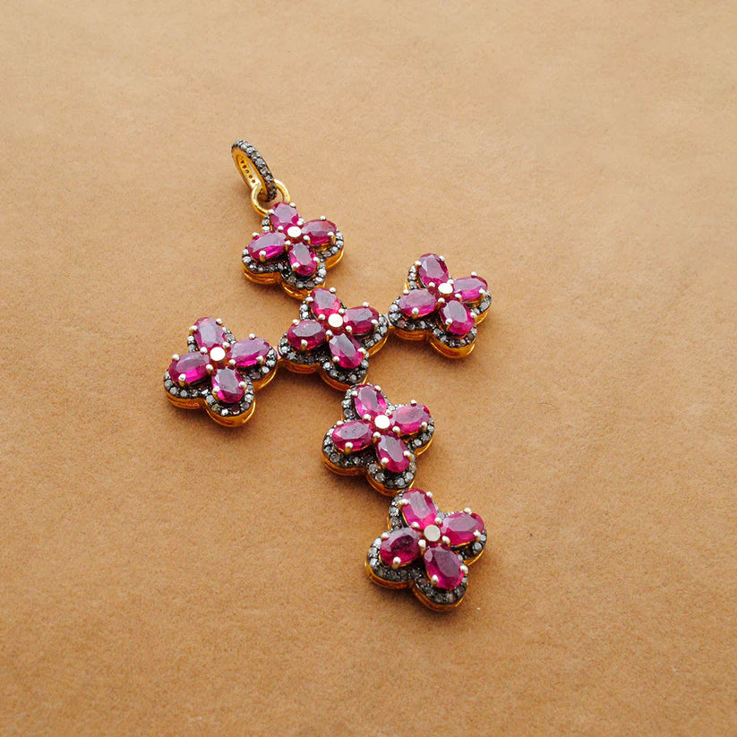 Gold-plated sterling silver pendant featuring a vivid ruby centerpiece surrounded by sparkling pavé-set diamonds in an elegant design
