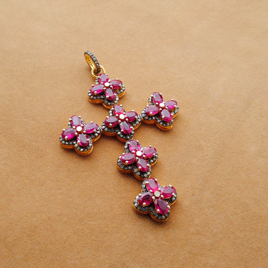 Gold-plated sterling silver pendant featuring a vivid ruby centerpiece surrounded by sparkling pavé-set diamonds in an elegant design