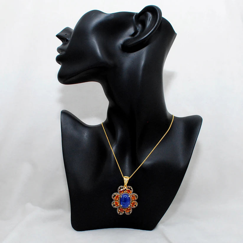 Gold-plated sterling silver pendant featuring tanzanite, sapphire, and black spinel gemstones accented with shimmering pavé-set diamonds in a luxurious design