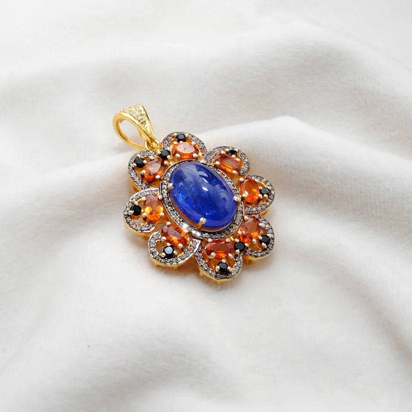 Gold-plated sterling silver pendant featuring tanzanite, sapphire, and black spinel gemstones accented with shimmering pavé-set diamonds in a luxurious design