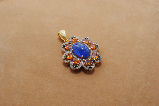 Gold-plated sterling silver pendant featuring tanzanite, sapphire, and black spinel gemstones accented with shimmering pavé-set diamonds in a luxurious design