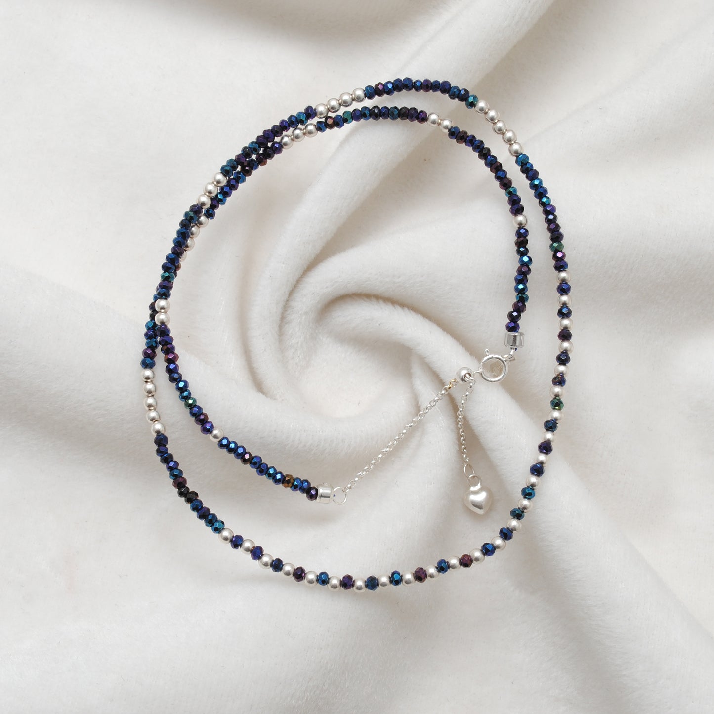 "Blue mystic coated faceted beaded necklace with silver clasp, iridescent shimmering gemstone jewelry, handcrafted design."