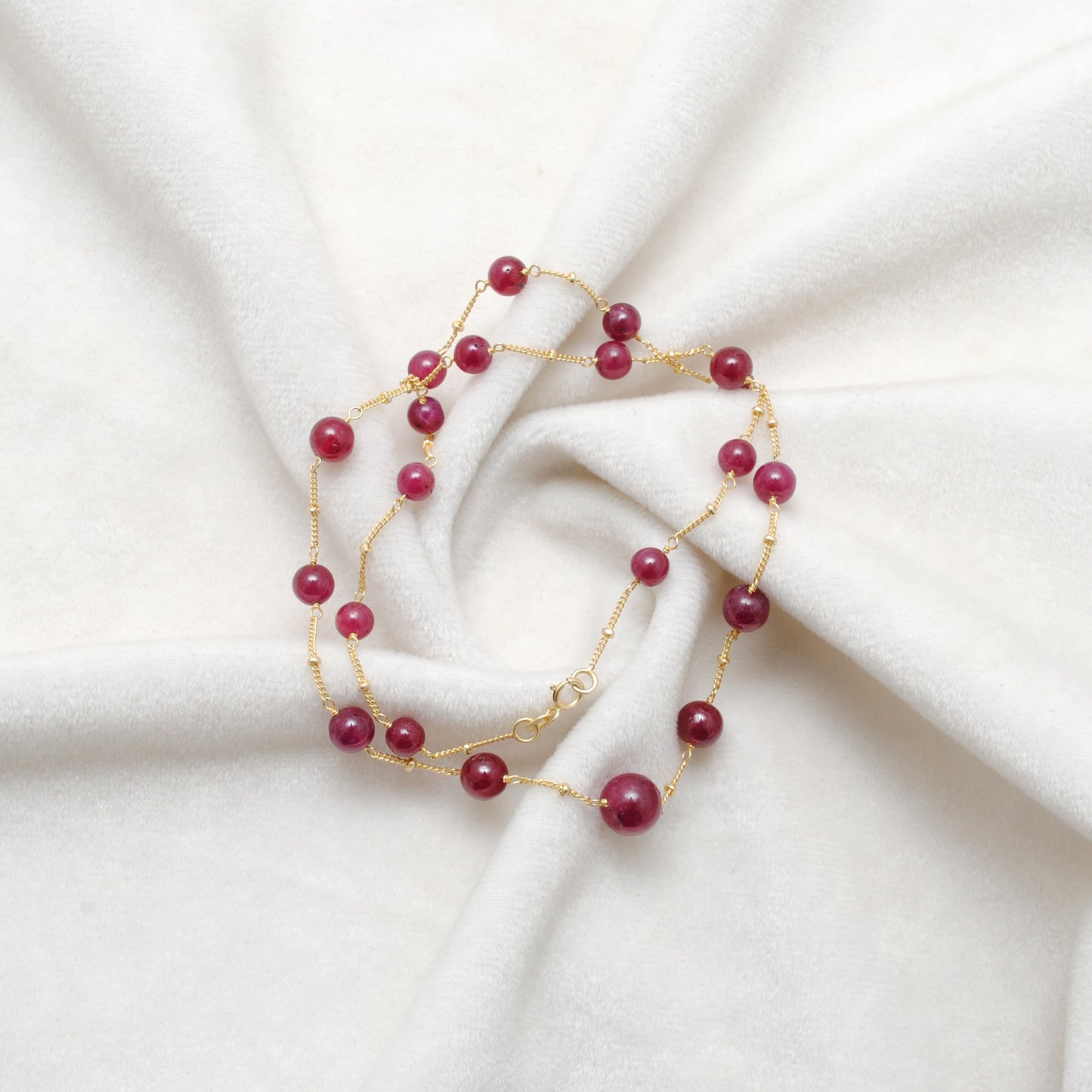 "Natural ruby ball bead necklace with sterling silver clasp, deep red gemstone jewelry, handcrafted elegant design."