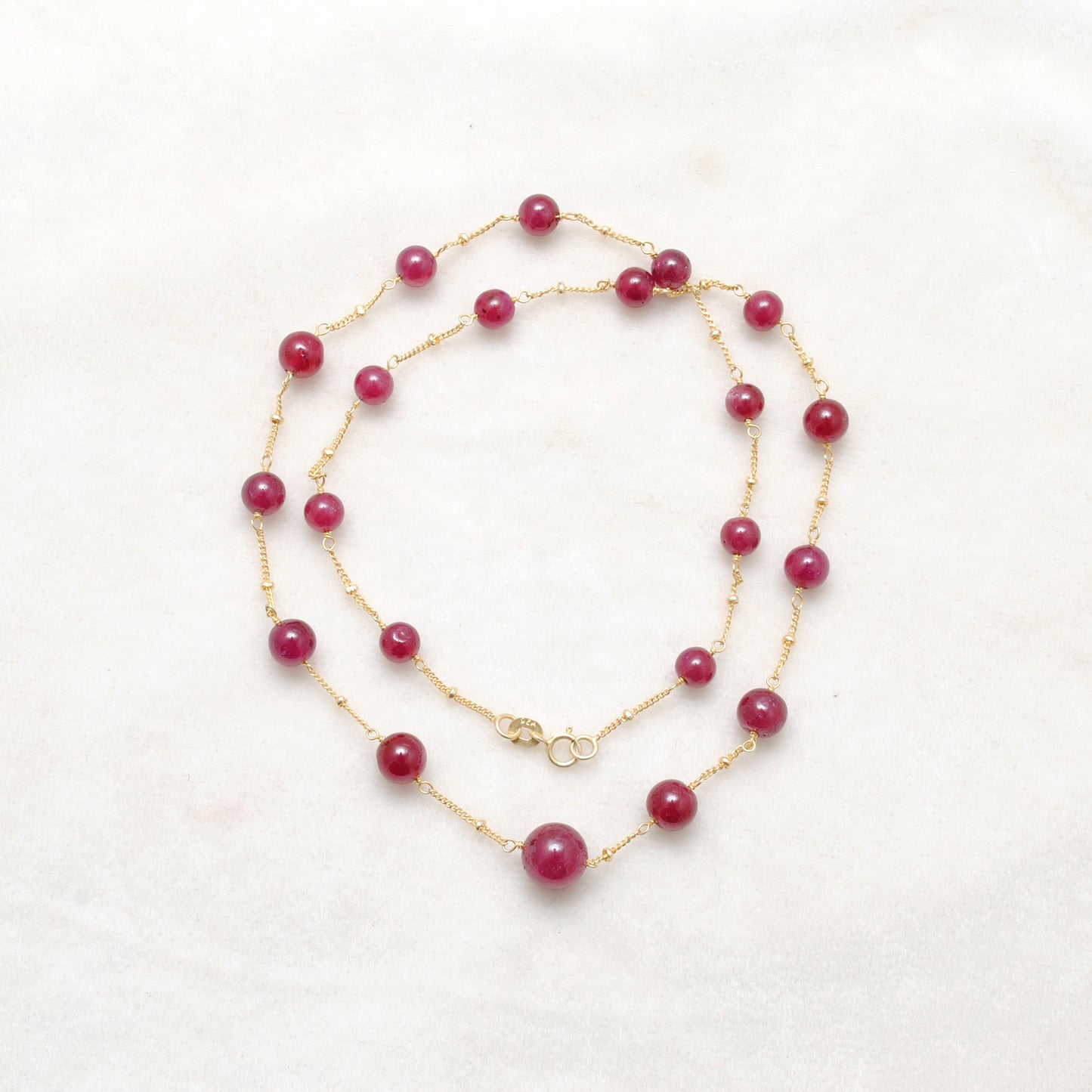 "Natural ruby ball bead necklace with sterling silver clasp, deep red gemstone jewelry, handcrafted elegant design."