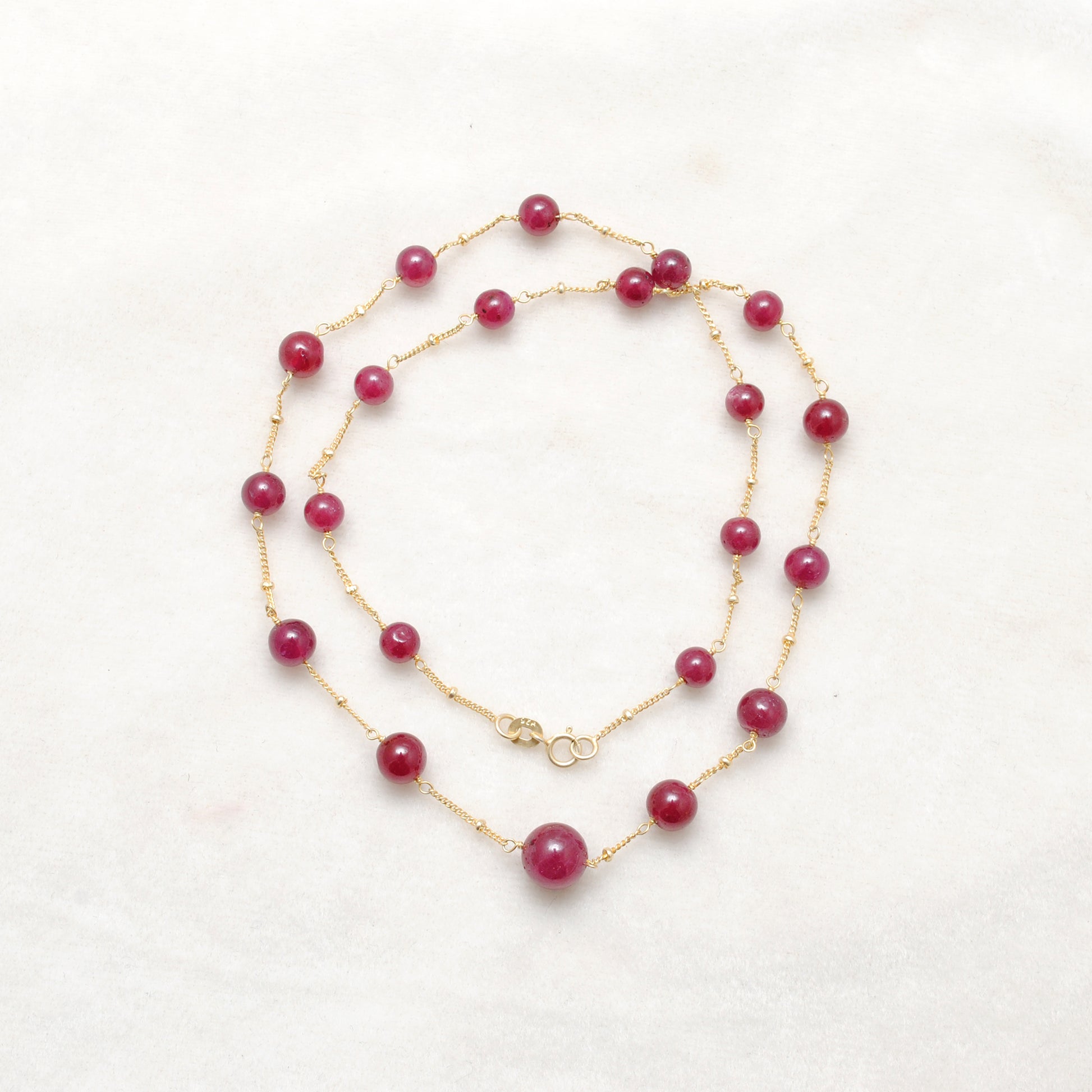 "Natural ruby ball bead necklace with sterling silver clasp, deep red gemstone jewelry, handcrafted elegant design."