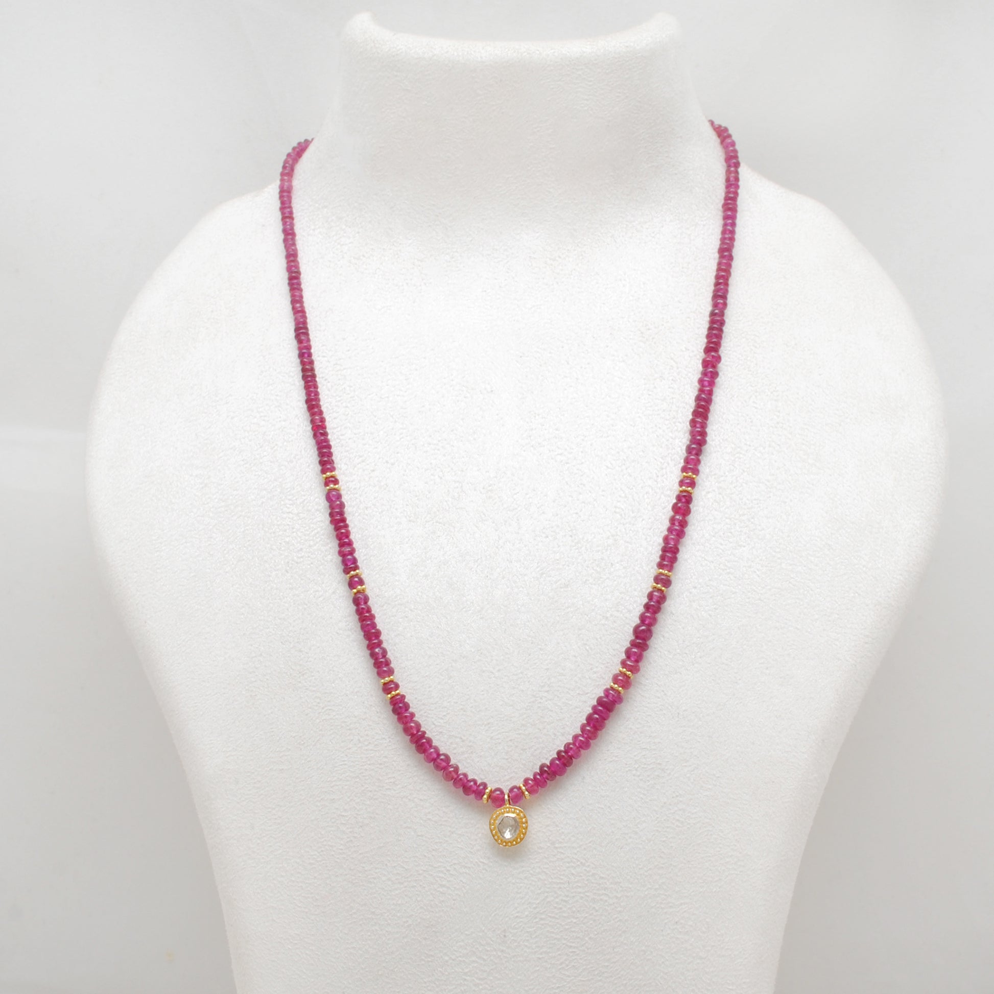 "Natural ruby beaded necklace with rose-cut diamond charm and sterling silver clasp, handcrafted jewelry with deep red gemstones for women."