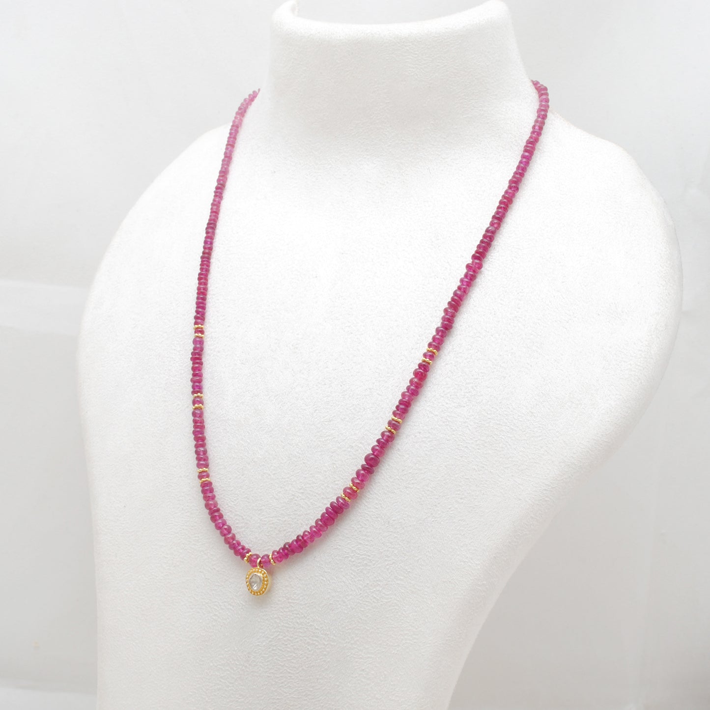 "Natural ruby beaded necklace with rose-cut diamond charm and sterling silver clasp, handcrafted jewelry with deep red gemstones for women."