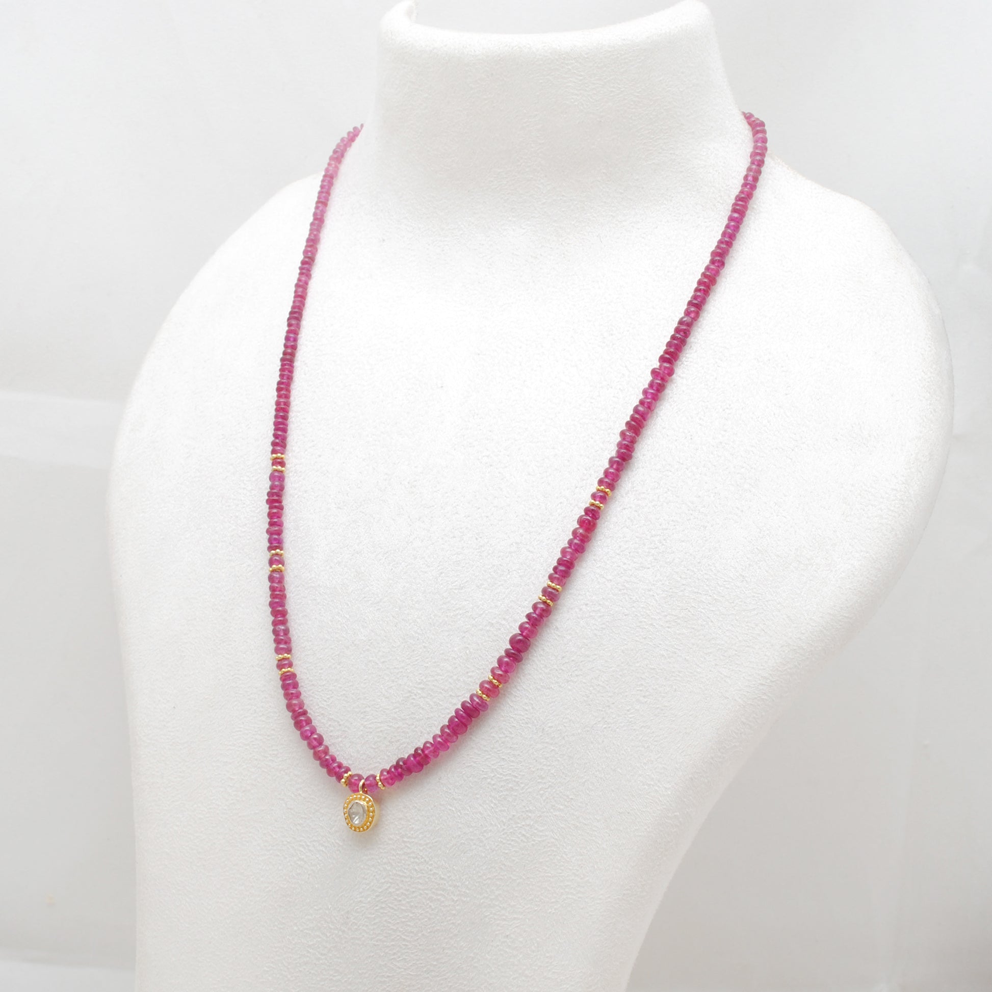 "Natural ruby beaded necklace with rose-cut diamond charm and sterling silver clasp, handcrafted jewelry with deep red gemstones for women."