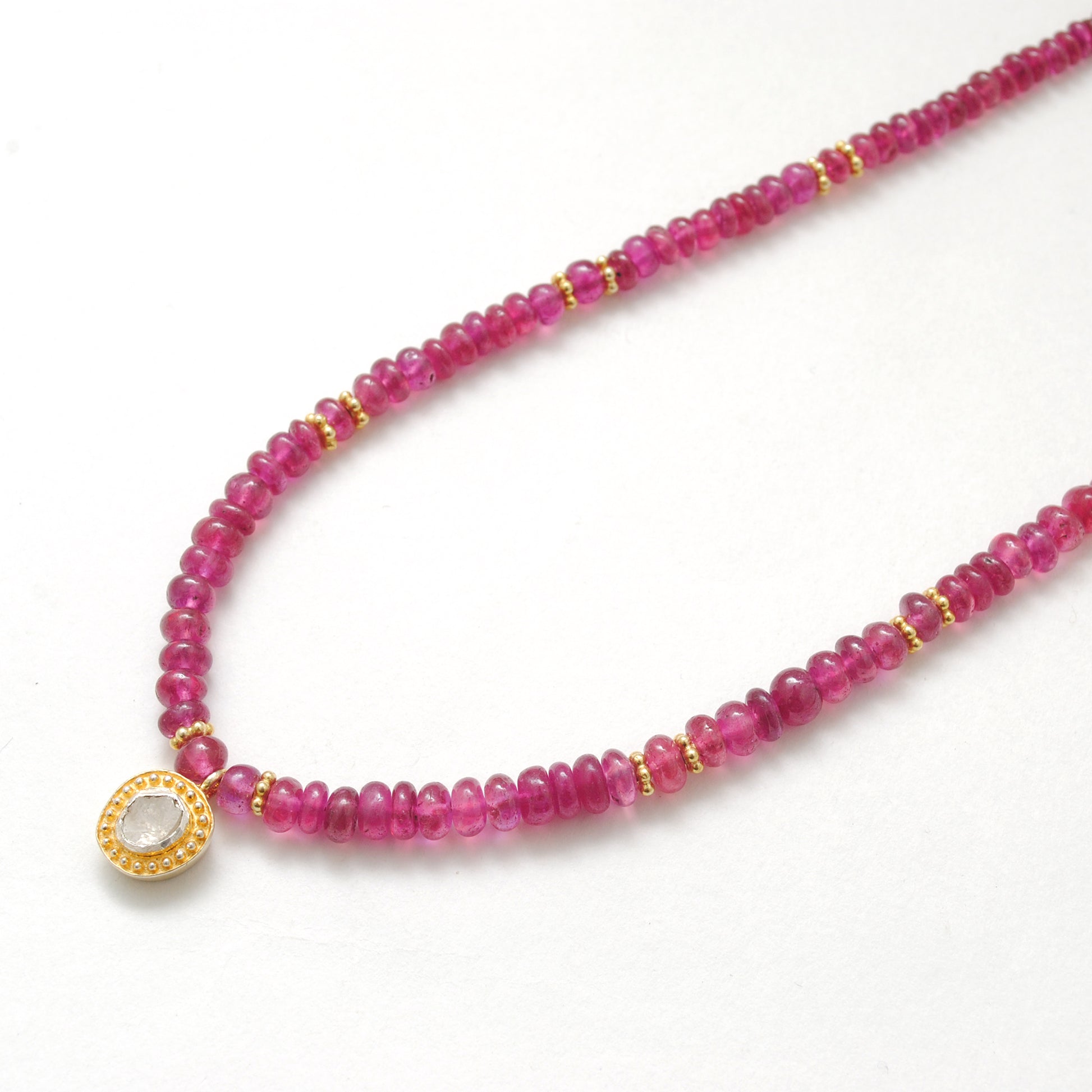 "Natural ruby beaded necklace with rose-cut diamond charm and sterling silver clasp, handcrafted jewelry with deep red gemstones for women."