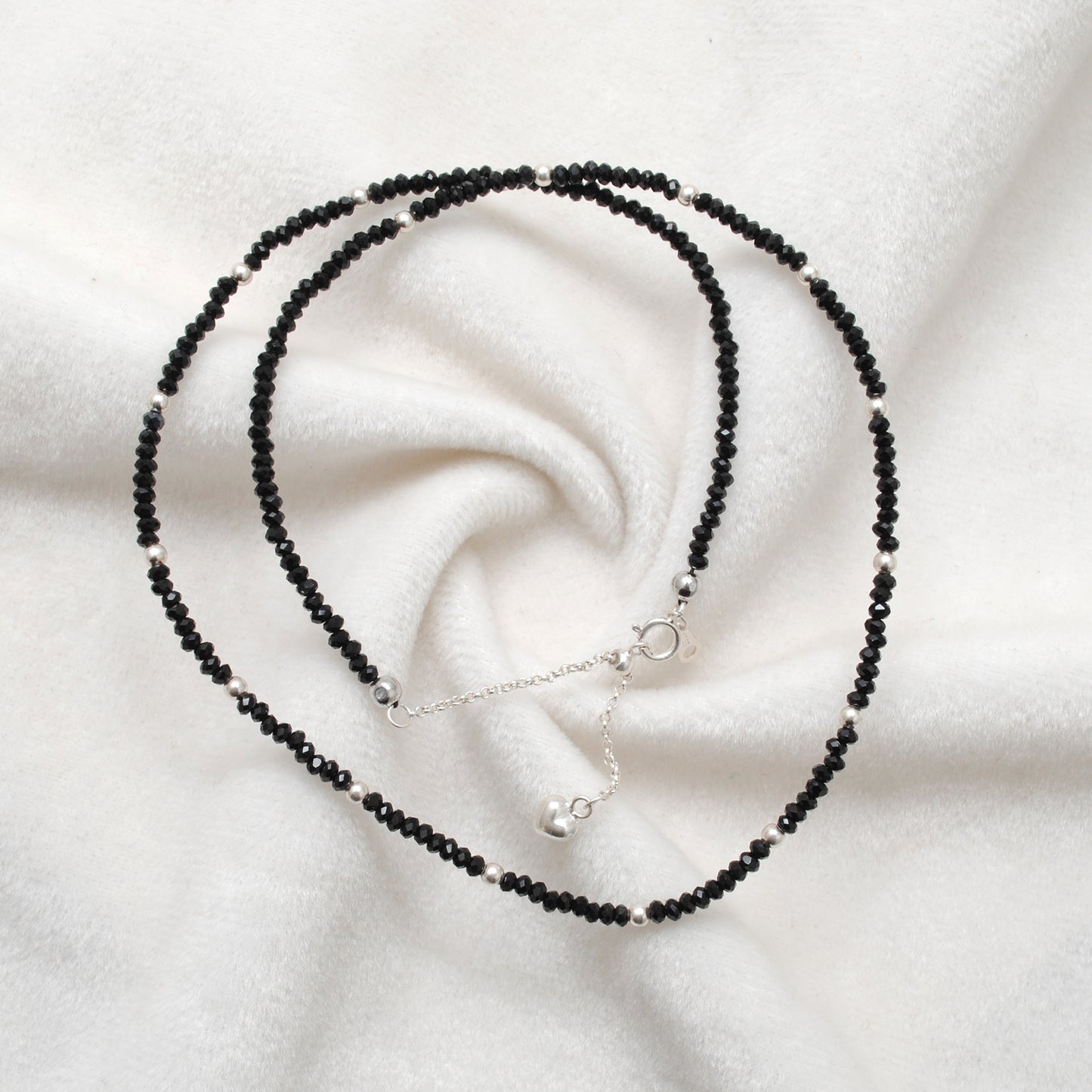 "Handmade black spinel beaded necklace with sterling silver clasp, faceted dark gemstone jewelry with subtle sparkle."