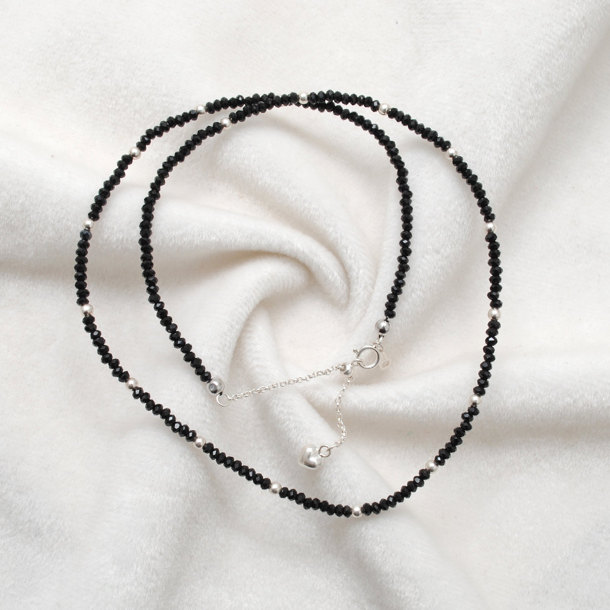 "Handmade black spinel beaded necklace with sterling silver clasp, faceted dark gemstone jewelry with subtle sparkle."