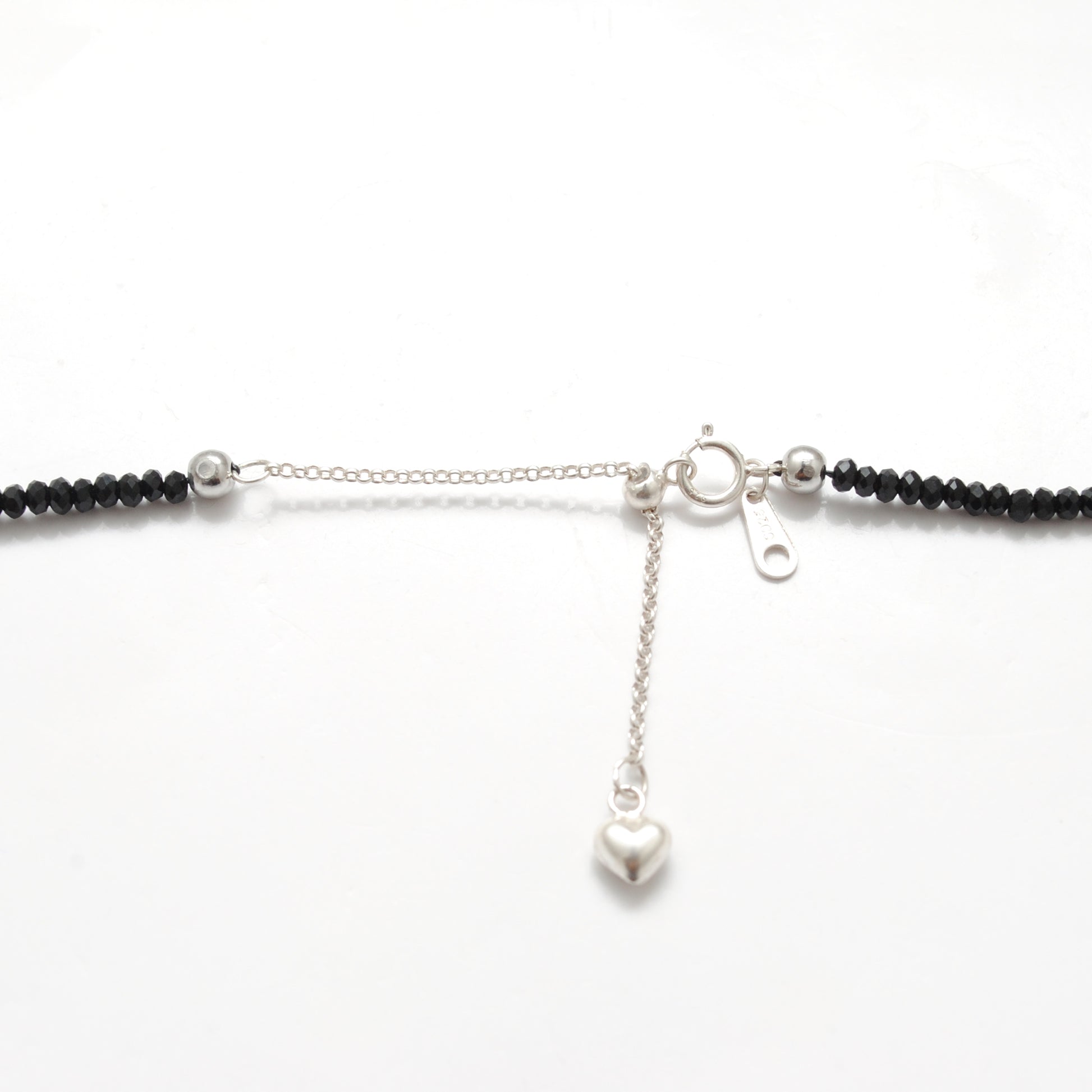 "Handmade black spinel beaded necklace with sterling silver clasp, faceted dark gemstone jewelry with subtle sparkle."