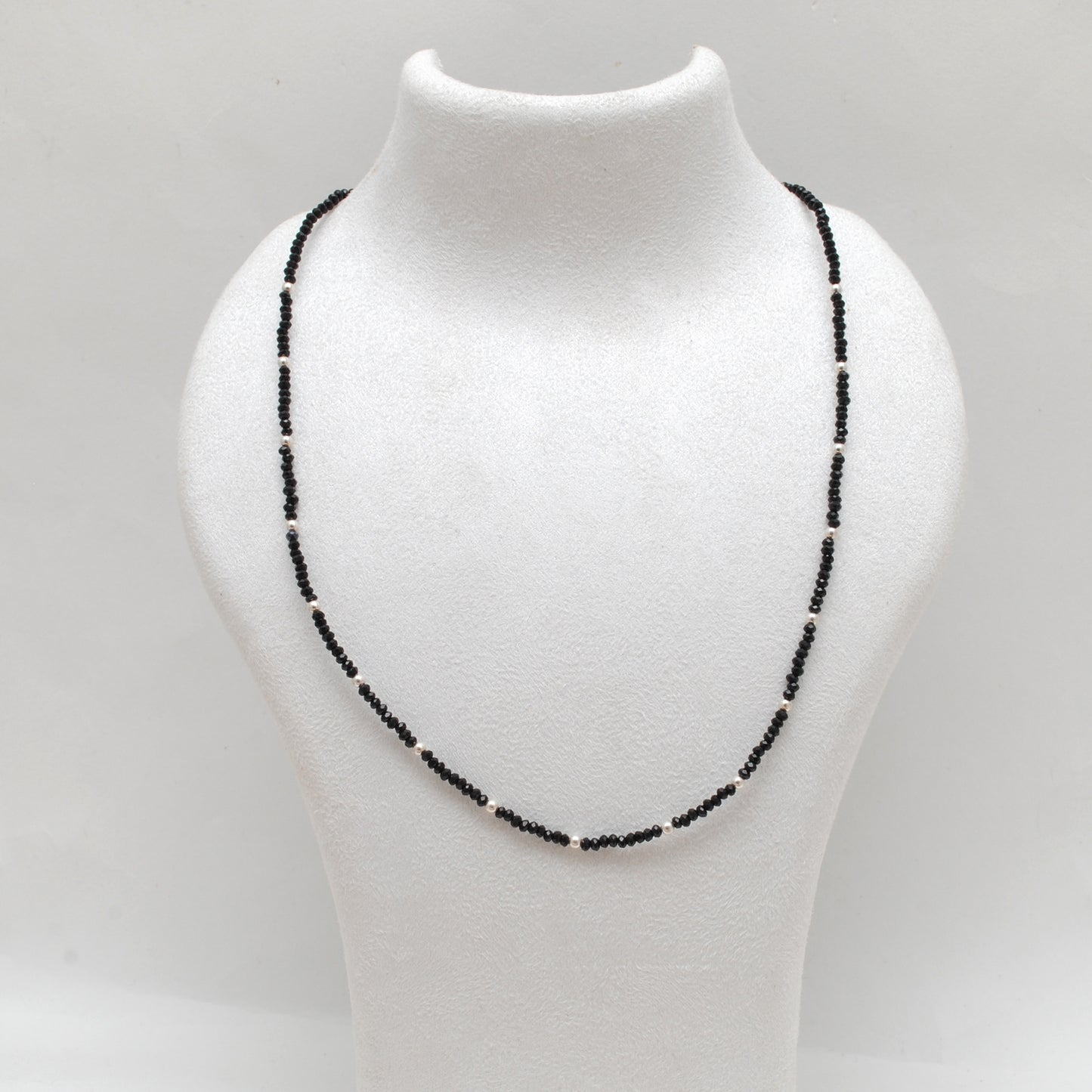 "Handmade black spinel beaded necklace with sterling silver clasp, faceted dark gemstone jewelry with subtle sparkle."